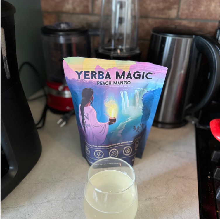 Yerba Magic pouch shown with a glass and electric frother on a kitchen counter.